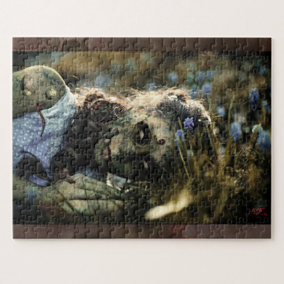 Assembled Gothic puzzle showing a fantastical creature amidst blue flowers; photomontage by Cyb.